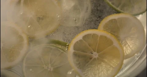 Macro lemonade with lime with bubbles on a black background Stock Footage 130361255
