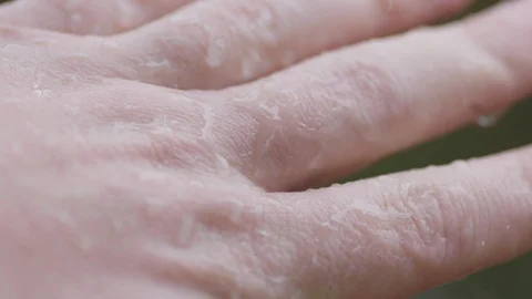 Macro Lens closeup: Rain splashes off adult man's hands and fingers, rainstorm. Video stock 101975718