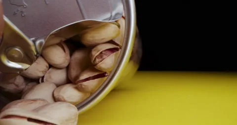 Macro lens, Macro shot, a woman's hand opens a can of pistachios in a beautiful Stock Footage 167725143