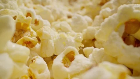Macro lens passing through popcorn. Popped popcorn. Dolly shot. Probe lens. Stock Footage 243487967