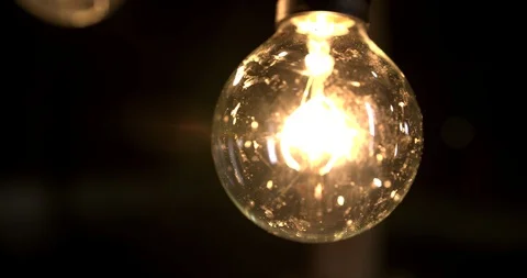 Macro of a light bulb in a dark barn Stock Footage 98357092