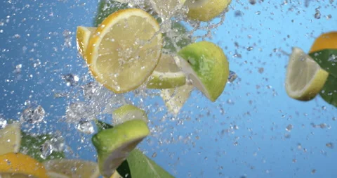 Macro of lime and lemon pieces fly with mint herbs, ice cubes and water drops Stock Footage 269926631