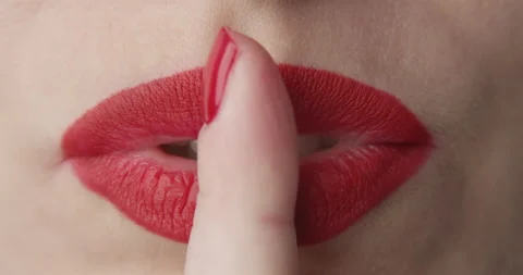 Macro of Lips with Red Lipstick and a Finger Showing Hush and Silence Stock Footage 166015200