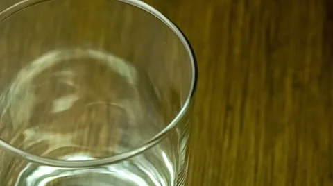 Macro of liquid soda pop beverage pouring into a clear glass cup with bubblin Stock Footage 62714098