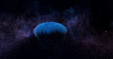 Macro of makeup brushes with flying cosmetic product powder particles splash Stock Footage 268980295
