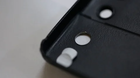 Macro making hole using paper puncher Stock Footage 123725494