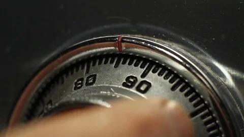 Macro of a man dialing a combination to open a safe Stock Footage 83711022