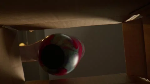 Macro Man pulling cup out box from underneath Stock Footage 307577123