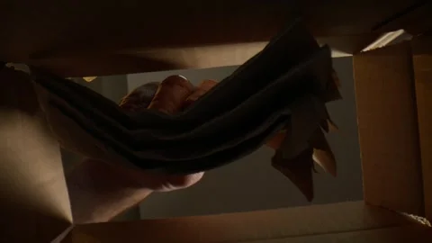 Macro of Man pulling napkins out of a box from underneath Stock Footage 307577146