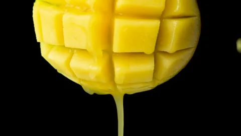 Macro of mango juice dripping from sliced fruit cubes, slow motion Stock Footage 327119163