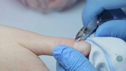 Macro, Master Manicure Cuts off Katikuly on Girl's Finger Stock Footage 97958269
