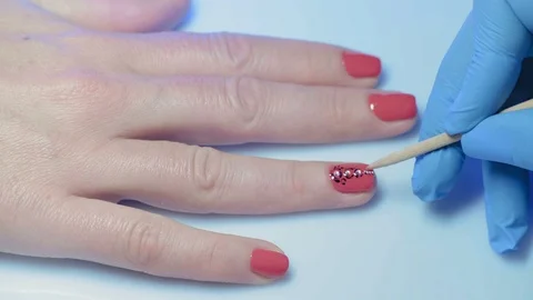 Macro, Master Manicure Decorates the Nail on the Girl's Hand with a Small Pearl Stock Footage 97960441