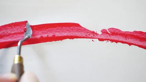 Macro. mastikhin, putty, brush on white paper or cloth, art. the artist paints Stock Footage 129622990