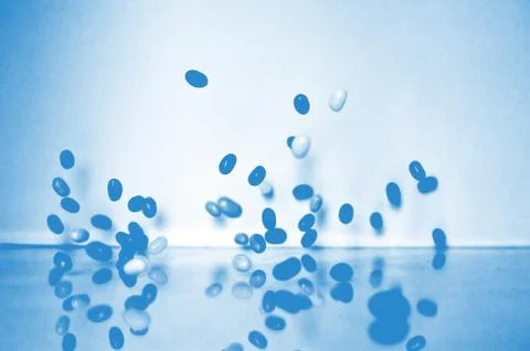 Macro of medicine falling Stock Photos