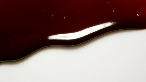 MACRO: Melted dark chocolate flows down on a white wall 動画素材 148469007