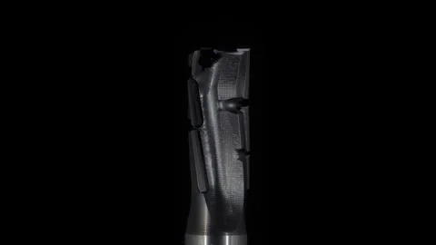 Macro, metal end mill rotates around the axis on a black background Stock Footage 302081986