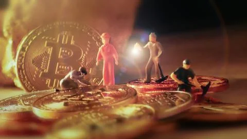 Macro miner figures working on group of Bitcoin mining in deep golden cave. v Stock Photos