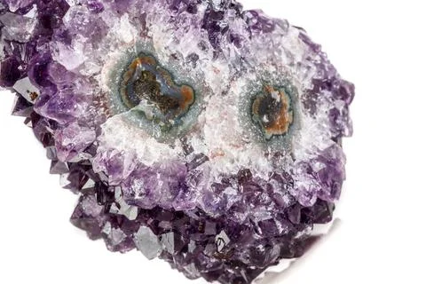 Macro mineral stone Amethyst eye, in the form of an owl on a white background Stock Photos