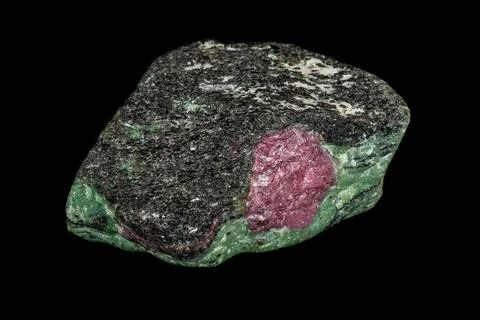 Macro of mineral stone ruby in rock on black background Stock Photos