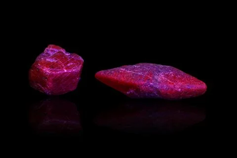 Macro mineral stone ruby under ultraviolet light on a black background 写真素材