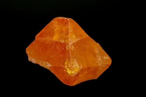 Macro mineral stone Scheelite on a black background Fotos Stock