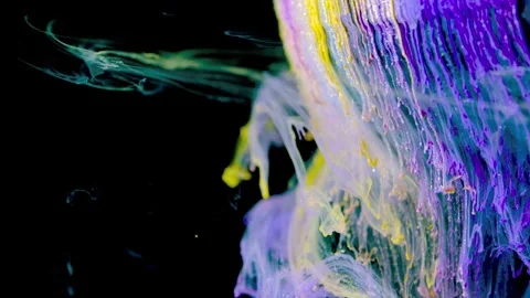 Macro motion of colorful ink clouds peeling into curling ribbons with droplets a Stock Footage 340781318