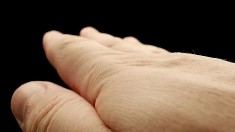 MACRO: Motion of a man's palm on a black background Stock Footage 174556059