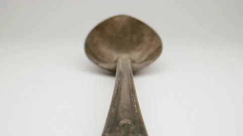 MACRO: Motion over antique spoon on a white background, Dolly shot Stock Footage 165190063
