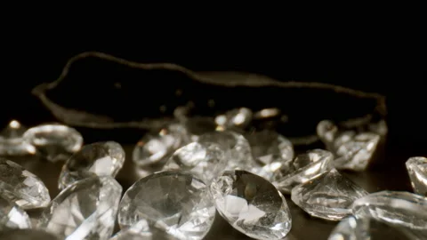 MACRO: Motion over many diamonds on black table Stock Footage 145825927