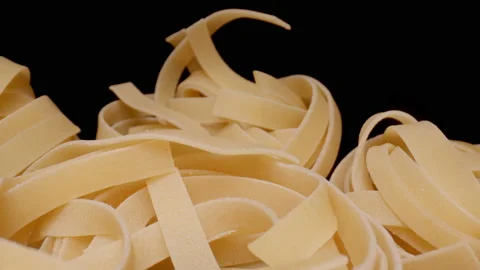 MACRO: Motion over nest pasta (Fettuccine) on a black background Vídeo Stock 144417437