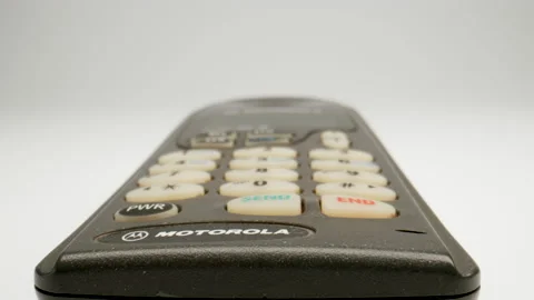 MACRO: Motion over outdated mobile phone on a white background, Dolly shot Stock Footage 165189514