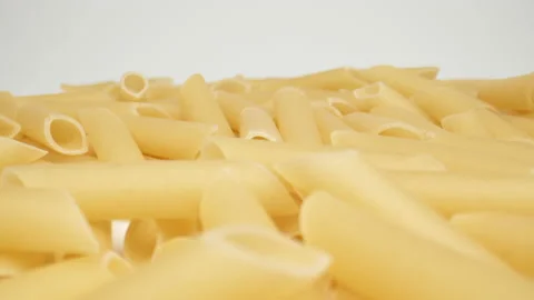MACRO: Motion over pasta (penne rigate) on a white background, Dolly shot Stock Footage 166029081