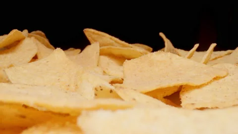 MACRO: Motion over potato chips on a black background 스톡 동영상 144417389