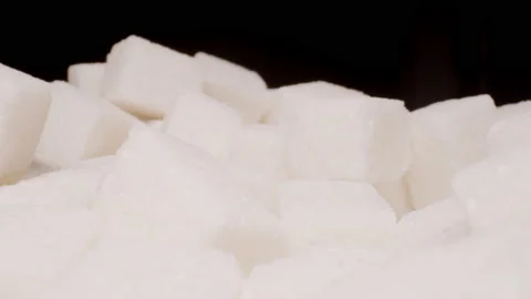 MACRO: Motion over sugar cubes on a black background Stock Footage 144417231