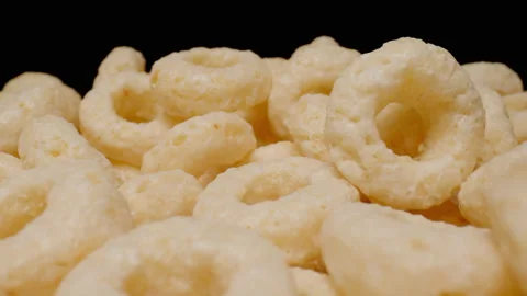 MACRO: Motion over sweet corn rings on a black background Stock Footage 145825759