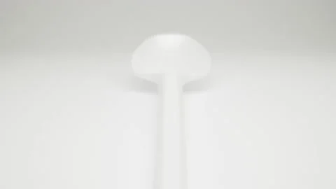 MACRO: Motion over white plastic spoon on a white background, Dolly shot Stock Footage 165190008