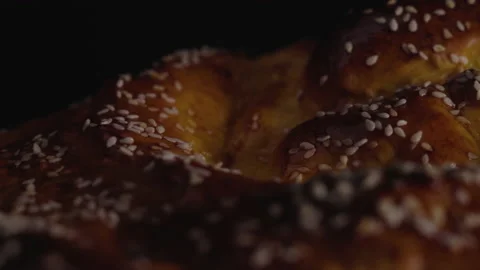 Macro, Move Left, Fresh Homemade Bread Sprinkled With Sesame Seeds on Black Stock Footage 147882679