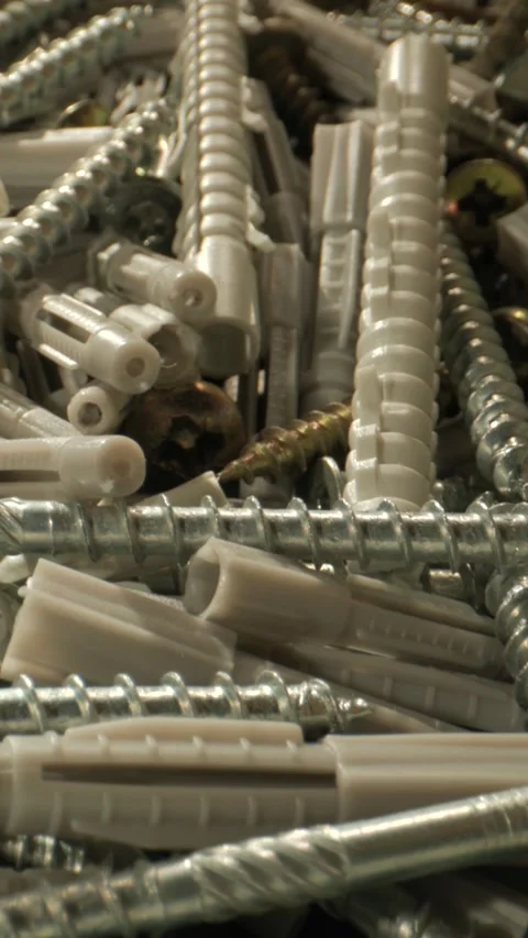 Macro Movement Capturing Clusters Of Metal Screws And Plastic Anchors With Detai Stock Footage 331720950