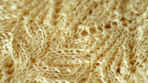 Macro with movement of soft yellow knitted fabric, extreme close up of cloth Stock Footage 244688208