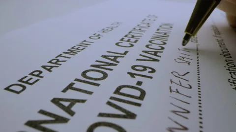 Macro moving shot of issuing Covid-19 international vaccination certificate Video stock 147309658
