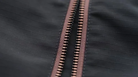 A macro moving video of an open zipper on a black jacket Stock Footage 343671758