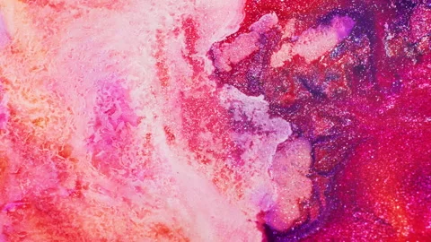 Macro of multicolored glitter ink pushed by air in fluid motion Stock Footage 314299656