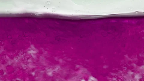 Macro of oily liquid forms bubbles in the water Stock-Footage 98363579