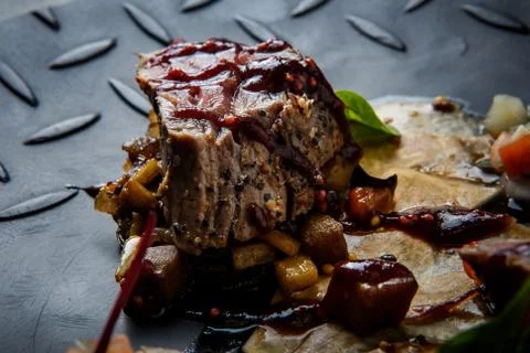 Macro one piece of medium raw grilled meat with vegetables Fotos de archivo