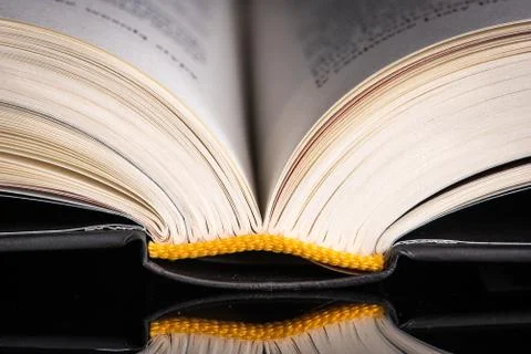 Macro of opened book with reflection Stock Photos