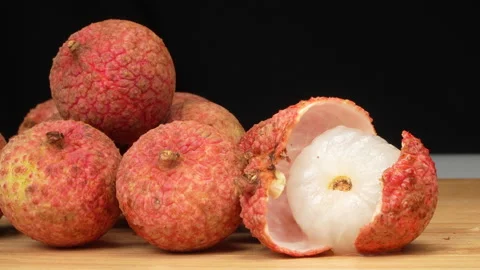 Macro of Opened Lychee Fruit Showing White Juicy Pulp Next to Whole Ripe Litchis Stock Footage 337326550