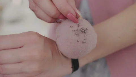 Macro or closeup shoot. Woman's hands takes a needle from a pillow with needles Stock Footage 107967947