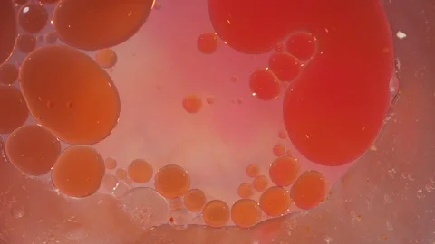 Macro of orange and pink liquid jelly bubbles moving and merging background 動画素材 118280207