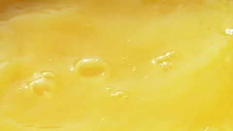 Macro orange fruit slice falling down into fresh orange juice drink, slow motion Stockbeeldmateriaal 145048837
