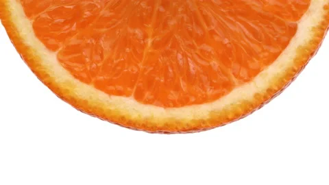 Macro of orange fruit slice part rotating on white background. Stock Footage 158913790